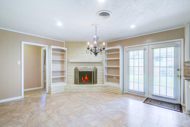 1708 Capstan Rd, Houston, TX 77062 - unfurnished living room featuring a chandelier, baseboards, ornamental molding, a textured ceiling, and built in features