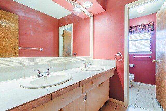 1708 Capstan Rd, Houston, TX 77062 - bathroom featuring toilet, tile patterned floors, double vanity, and baseboards