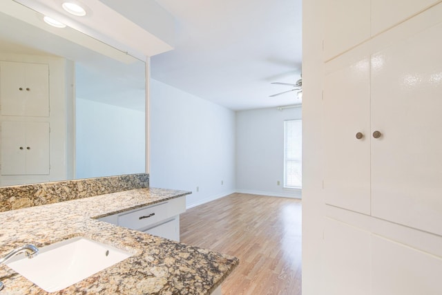 1708 Capstan Rd, Houston, TX 77062 - bathroom featuring wood finished floors, ceiling fan, baseboards, and vanity