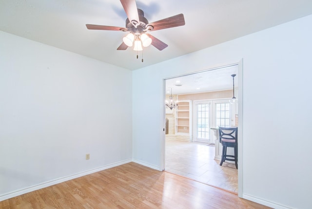 1708 Capstan Rd, Houston, TX 77062 - spare room with light wood-type flooring, a ceiling fan, baseboards, and a chandelier