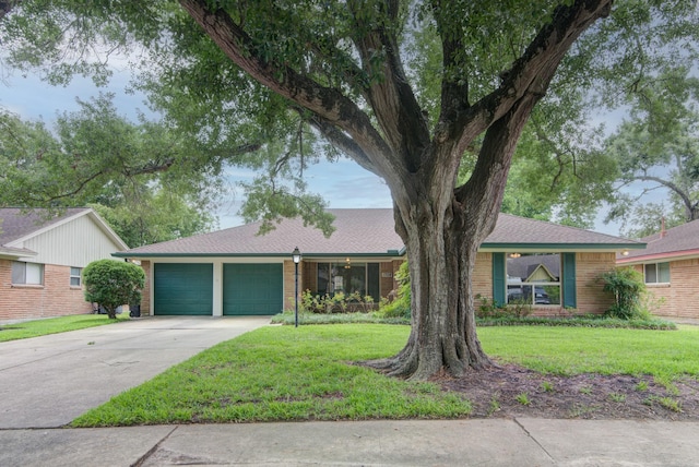 1708 Capstan Rd, Houston, TX 77062 - ranch-style home with a garage, driveway, a front yard, and brick siding
