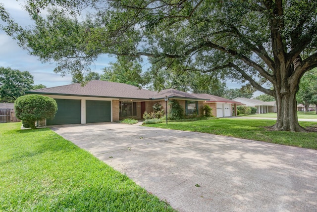 1708 Capstan Rd, Houston, TX 77062 - ranch-style home with a garage, a front lawn, concrete driveway, and brick siding