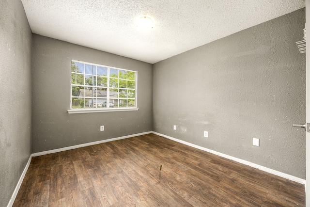 18627 Spinney Lane Dr, Cypress, TX 77433 - empty room with wood finished floors, a textured wall, baseboards, and a textured ceiling