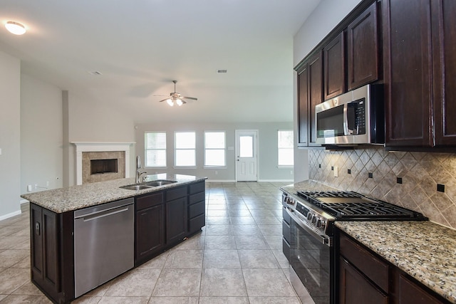 11819 Eagle Ridge Dr, Mont Belvieu, TX 77535 - kitchen featuring stainless steel appliances, a sink, ceiling fan, open floor plan, and baseboards