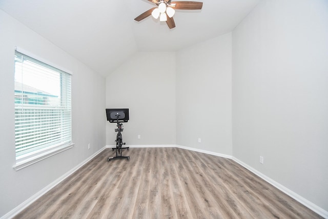 11819 Eagle Ridge Dr, Mont Belvieu, TX 77535 - empty room featuring a ceiling fan, wood finished floors, lofted ceiling, and baseboards