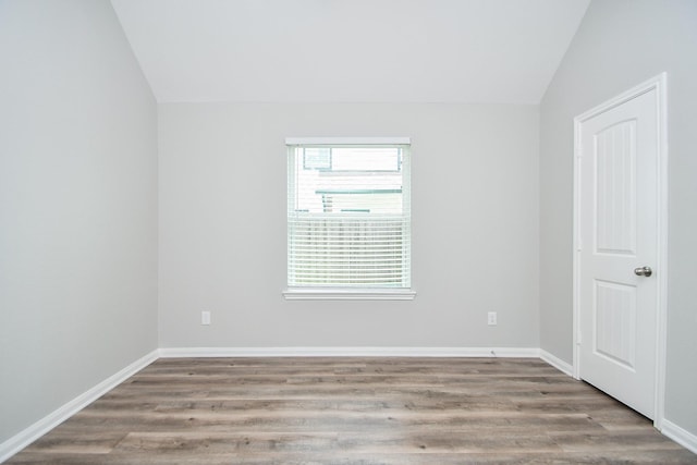 11819 Eagle Ridge Dr, Mont Belvieu, TX 77535 - unfurnished room with vaulted ceiling, wood finished floors, and baseboards