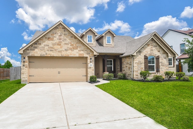 11819 Eagle Ridge Dr, Mont Belvieu, TX 77535 - view of front of home with stone siding, driveway, a garage, and a shingled roof