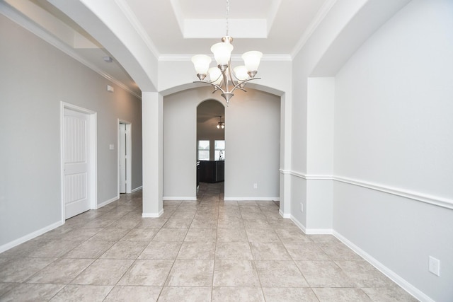 11819 Eagle Ridge Dr, Mont Belvieu, TX 77535 - unfurnished room with arched walkways, a chandelier, a raised ceiling, crown molding, and light tile patterned floors
