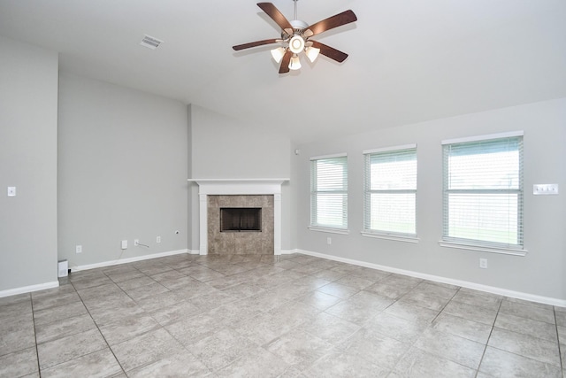 11819 Eagle Ridge Dr, Mont Belvieu, TX 77535 - unfurnished living room with a ceiling fan, vaulted ceiling, a tiled fireplace, and baseboards