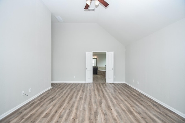 11819 Eagle Ridge Dr, Mont Belvieu, TX 77535 - unfurnished bedroom with wood finished floors, lofted ceiling, baseboards, ensuite bathroom, and ceiling fan