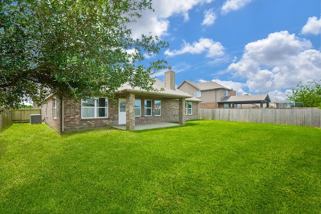 11819 Eagle Ridge Dr, Mont Belvieu, TX 77535 - rear view of property featuring a patio area, brick siding, a chimney, and central air condition unit