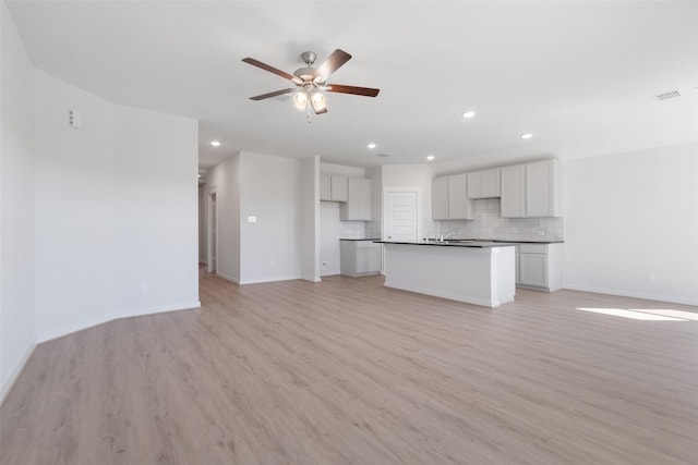 4609 Peony Green Dr, Katy, TX 77493 - unfurnished living room featuring light wood-style flooring, ceiling fan, and recessed lighting