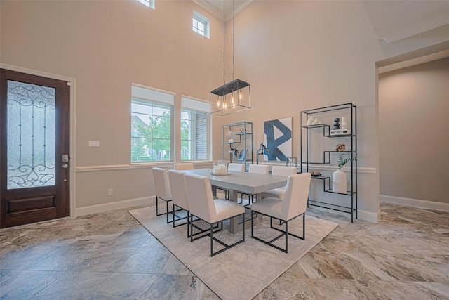 442 Imperial Blvd, Sugar Land, TX 77498 - dining area with a chandelier, a high ceiling, baseboards, and ornamental molding
