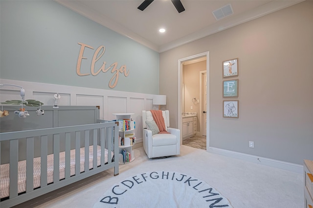 442 Imperial Blvd, Sugar Land, TX 77498 - carpeted bedroom with a crib, crown molding, wainscoting, a decorative wall, and ceiling fan