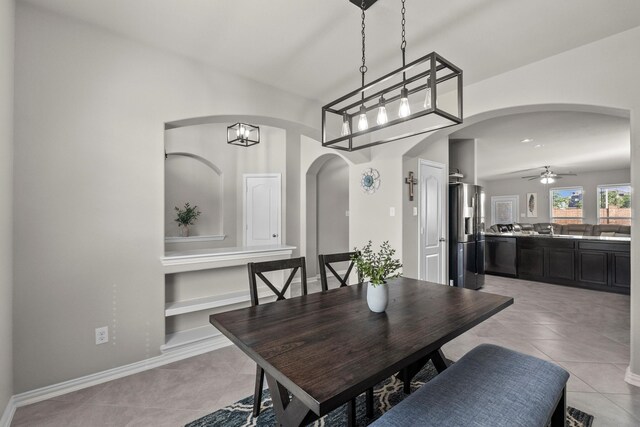 2525 Galley Ridge Dr, La Marque, TX 77568 - dining area featuring light tile patterned floors, a ceiling fan, arched walkways, built in features, and baseboards