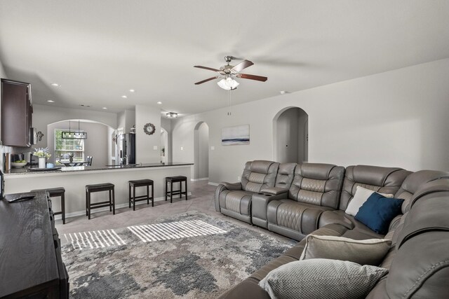 2525 Galley Ridge Dr, La Marque, TX 77568 - living room featuring arched walkways, ceiling fan, baseboards, recessed lighting, and light carpet
