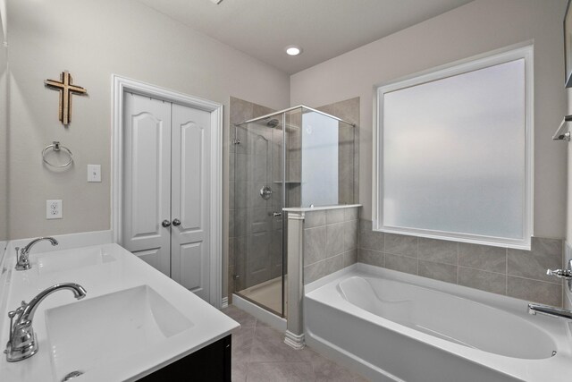 2525 Galley Ridge Dr, La Marque, TX 77568 - full bathroom featuring a bath, a stall shower, tile patterned flooring, and double vanity