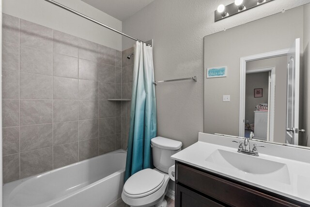 2525 Galley Ridge Dr, La Marque, TX 77568 - bathroom featuring vanity, shower / tub combo with curtain, toilet, and a textured wall