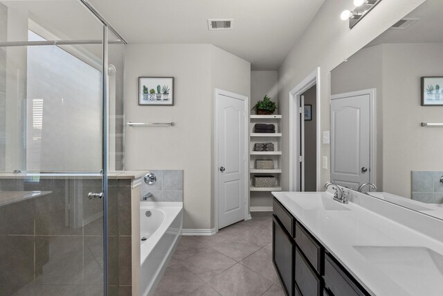 2525 Galley Ridge Dr, La Marque, TX 77568 - full bathroom featuring a garden tub, double vanity, a shower stall, tile patterned flooring, and baseboards
