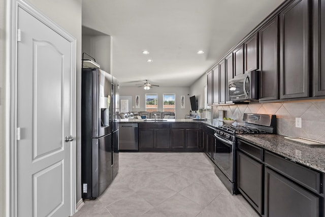 2525 Galley Ridge Dr, La Marque, TX 77568 - kitchen featuring stainless steel appliances, a ceiling fan, dark brown cabinetry, dark stone countertops, and recessed lighting
