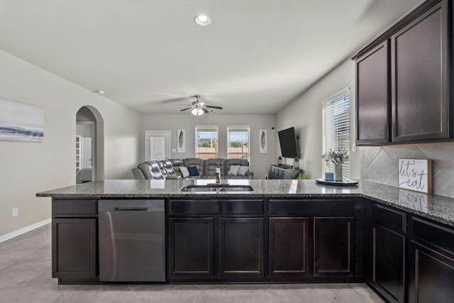 2525 Galley Ridge Dr, La Marque, TX 77568 - kitchen with dishwasher, a sink, dark stone counters, arched walkways, and open floor plan