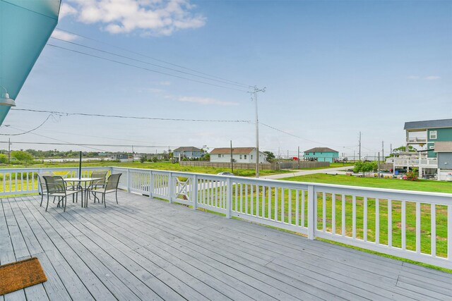 1004 20th St, Dickinson, TX 77539 - wooden terrace with a lawn and outdoor dining area