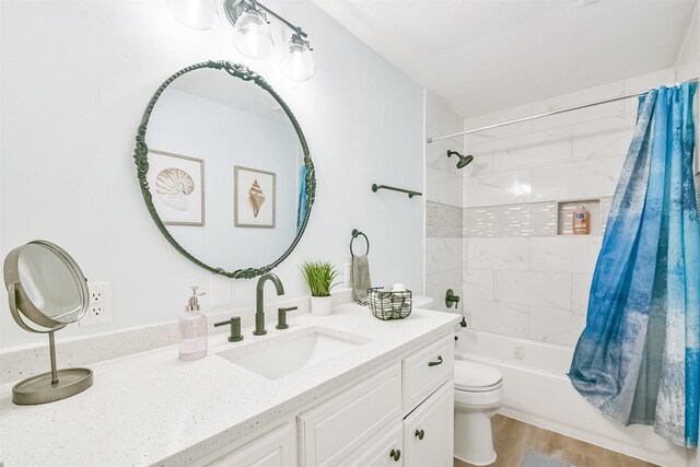 1004 20th St, Dickinson, TX 77539 - full bath featuring toilet, vanity, shower / tub combo, and wood finished floors