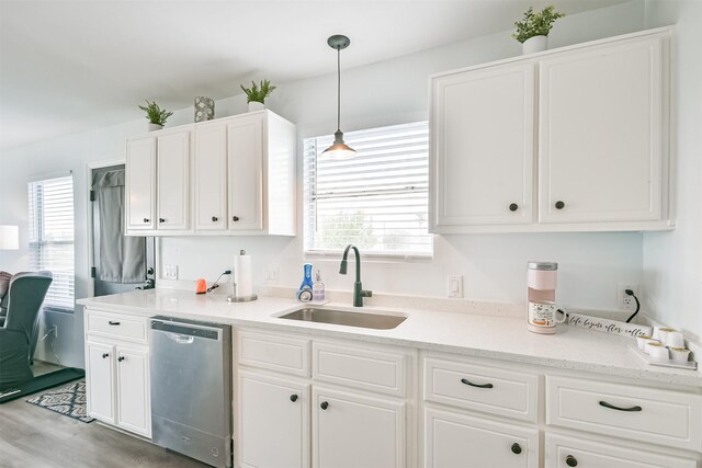 1004 20th St, Dickinson, TX 77539 - kitchen with dishwasher, a sink, and white cabinetry