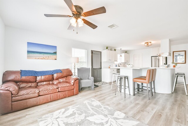 1004 20th St, Dickinson, TX 77539 - living room with light wood-type flooring and a ceiling fan
