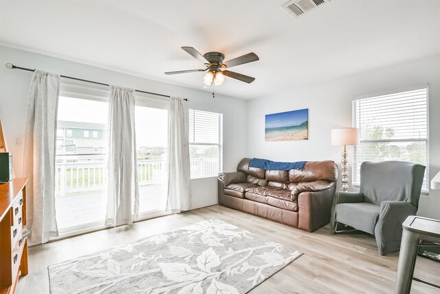 1004 20th St, Dickinson, TX 77539 - living area with ceiling fan and light wood-style flooring