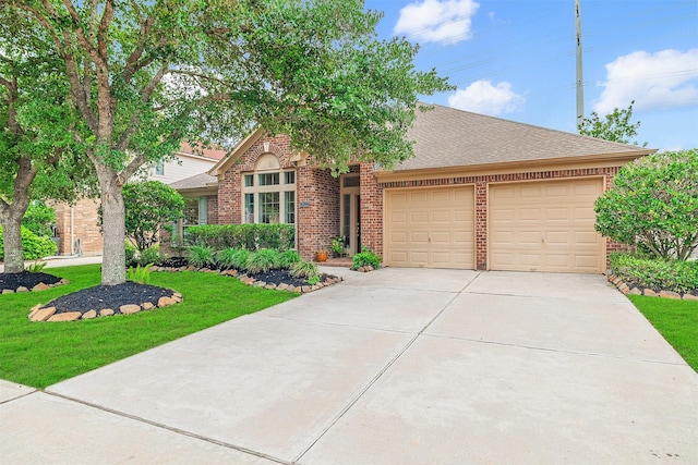26122 Savory Springs Ln, Katy, TX 77494 - view of front facade featuring brick siding, an attached garage, concrete driveway, a front lawn, and a shingled roof