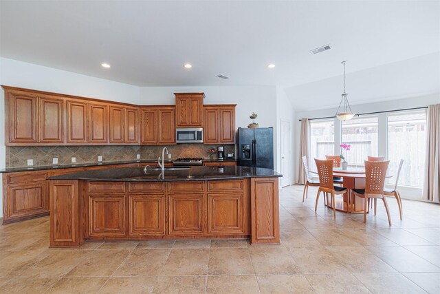 26122 Savory Springs Ln, Katy, TX 77494 - kitchen featuring stainless steel microwave, black fridge, brown cabinets, a sink, and recessed lighting