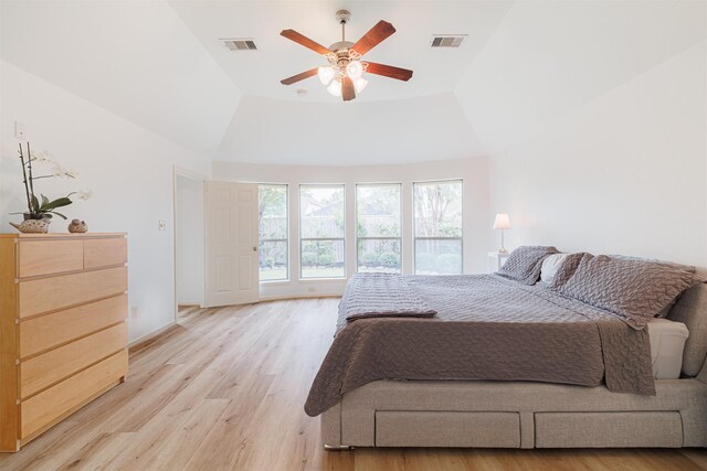 26122 Savory Springs Ln, Katy, TX 77494 - bedroom featuring light wood-style floors, a tray ceiling, and a ceiling fan