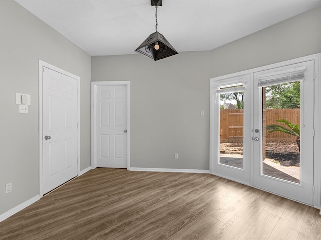20211 Sunrise Glen Ct, Spring, TX 77379 - unfurnished dining area with wood finished floors, french doors, and baseboards