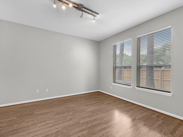 20211 Sunrise Glen Ct, Spring, TX 77379 - empty room with wood finished floors, track lighting, and baseboards