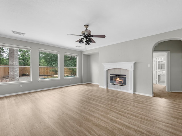 20211 Sunrise Glen Ct, Spring, TX 77379 - unfurnished living room featuring healthy amount of natural light, crown molding, light wood-style flooring, and ceiling fan