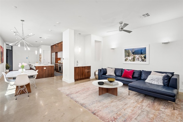 509 W Drew St, Houston, TX 77006 - living area featuring finished concrete floors, baseboards, a chandelier, and a ceiling fan