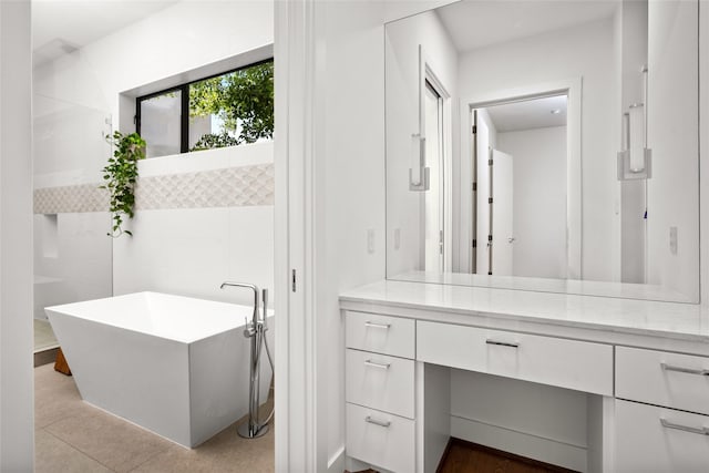 509 W Drew St, Houston, TX 77006 - bathroom featuring a freestanding tub, tile walls, tile patterned floors, and vanity