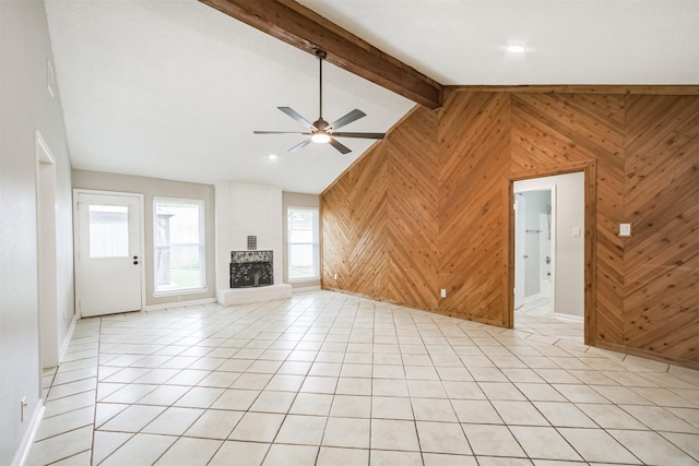 22519 Elkana Deane Ln, Katy, TX 77449 - unfurnished living room with wooden walls, a ceiling fan, baseboards, light tile patterned floors, and a fireplace