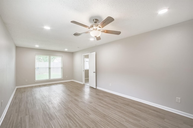 22519 Elkana Deane Ln, Katy, TX 77449 - unfurnished room with ceiling fan, wood finished floors, baseboards, recessed lighting, and a textured ceiling