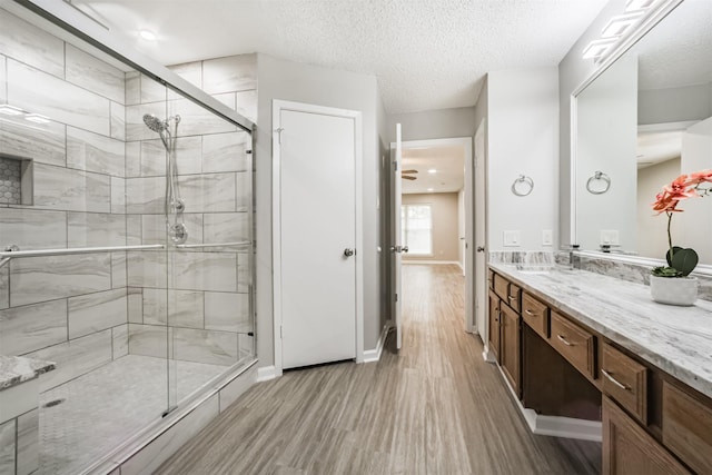 22519 Elkana Deane Ln, Katy, TX 77449 - full bath featuring a shower stall, wood finished floors, vanity, and baseboards