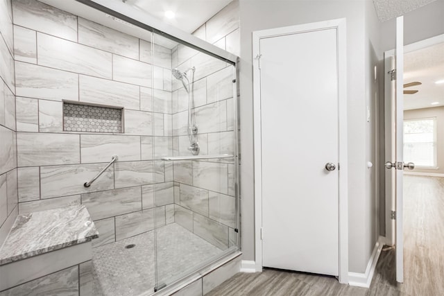 22519 Elkana Deane Ln, Katy, TX 77449 - bathroom with a stall shower, wood finished floors, and baseboards