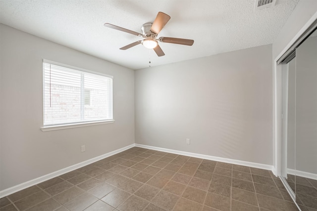 22519 Elkana Deane Ln, Katy, TX 77449 - tiled empty room featuring ceiling fan, a textured ceiling, and baseboards