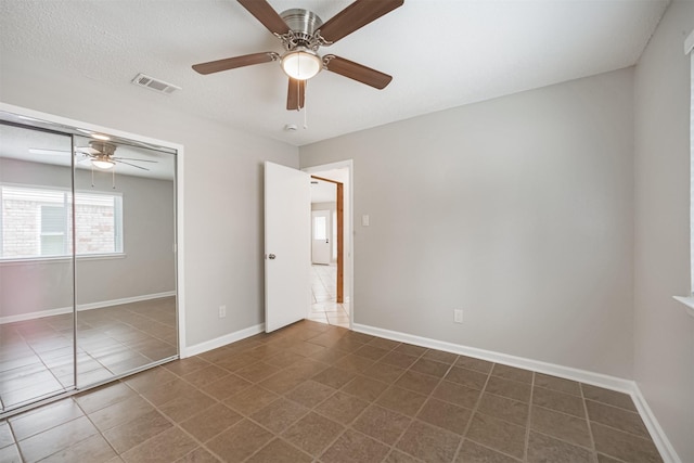 22519 Elkana Deane Ln, Katy, TX 77449 - unfurnished bedroom featuring dark tile patterned floors, a closet, ceiling fan, and baseboards