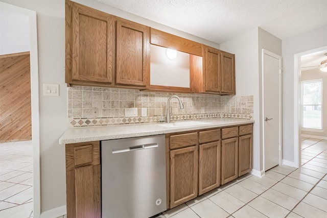 22519 Elkana Deane Ln, Katy, TX 77449 - kitchen with dishwasher, a sink, light countertops, tasteful backsplash, and a textured ceiling