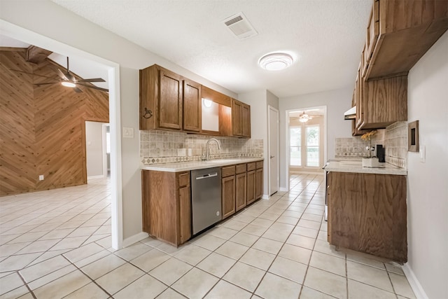 22519 Elkana Deane Ln, Katy, TX 77449 - kitchen with dishwasher, a ceiling fan, light countertops, and wooden walls