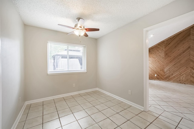 22519 Elkana Deane Ln, Katy, TX 77449 - spare room with light tile patterned floors, a ceiling fan, a textured ceiling, and baseboards