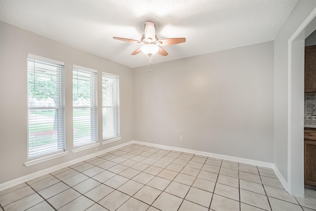 22519 Elkana Deane Ln, Katy, TX 77449 - spare room with healthy amount of natural light, a ceiling fan, light tile patterned floors, and baseboards