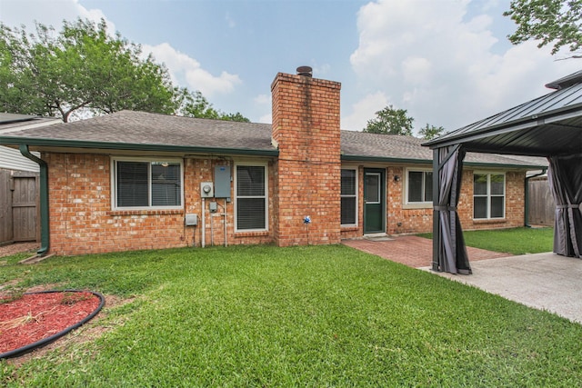 22519 Elkana Deane Ln, Katy, TX 77449 - rear view of property featuring a chimney, brick siding, a patio, roof with shingles, and a gazebo