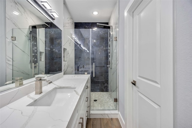 4923 Golden Forest St Unit A, Houston, TX 77091 - bathroom featuring wood finished floors, a marble finish shower, vanity, and recessed lighting